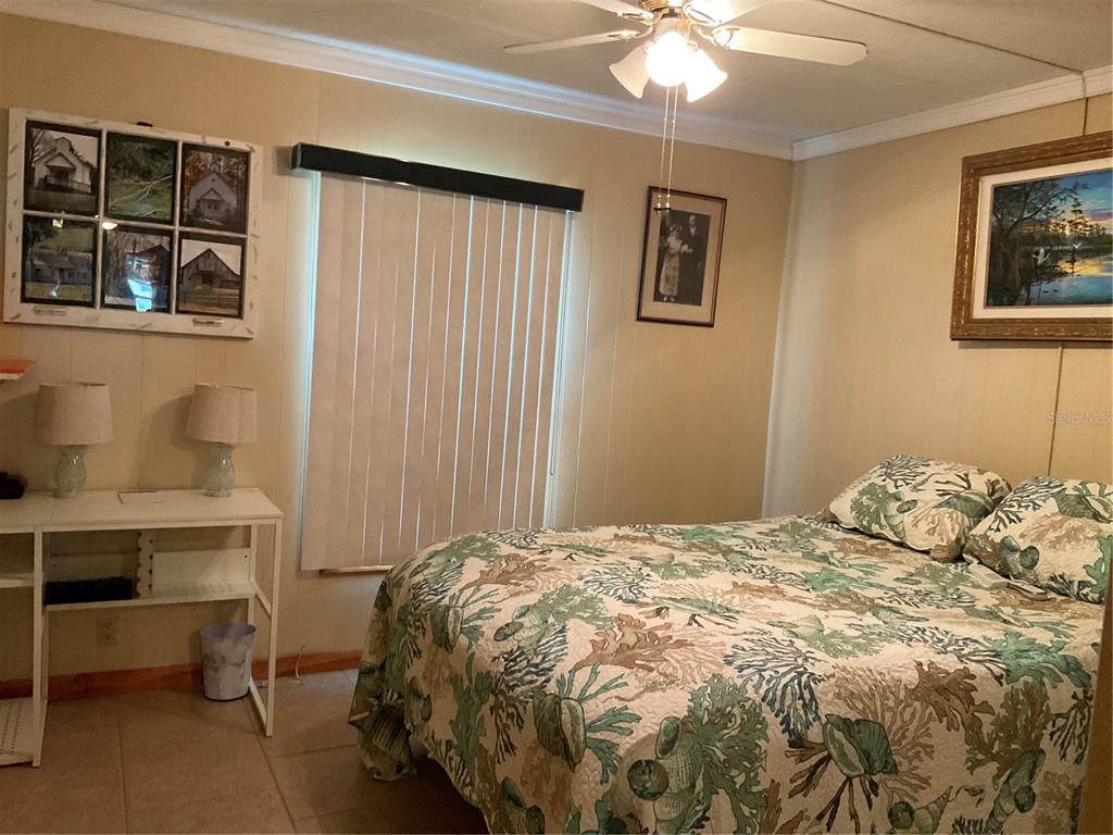 1558 Chobee Street Okeechobee, FL 34974 - Photo 39 of 63 a bedroom with a bed and a window