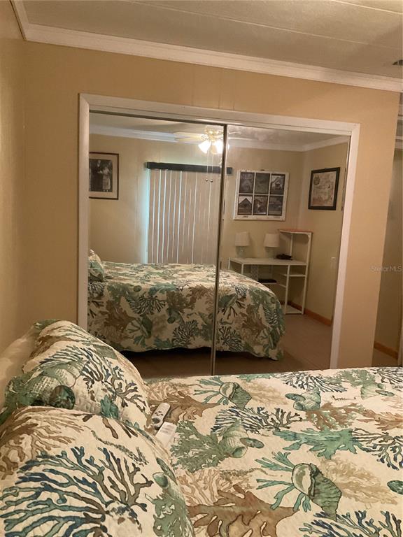 1558 Chobee Street Okeechobee, FL 34974 - Photo 40 of 63 a bedroom with a bed and wooden floor