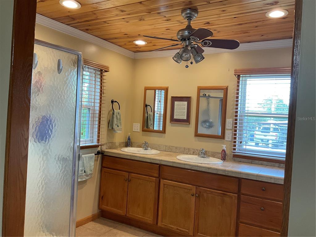 1558 Chobee Street Okeechobee, FL 34974 - Photo 41 of 63 a bathroom with a granite countertop sink and a mirror
