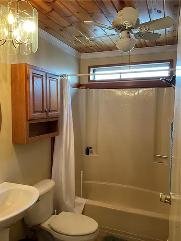 a view of an empty room with a chandelier fan