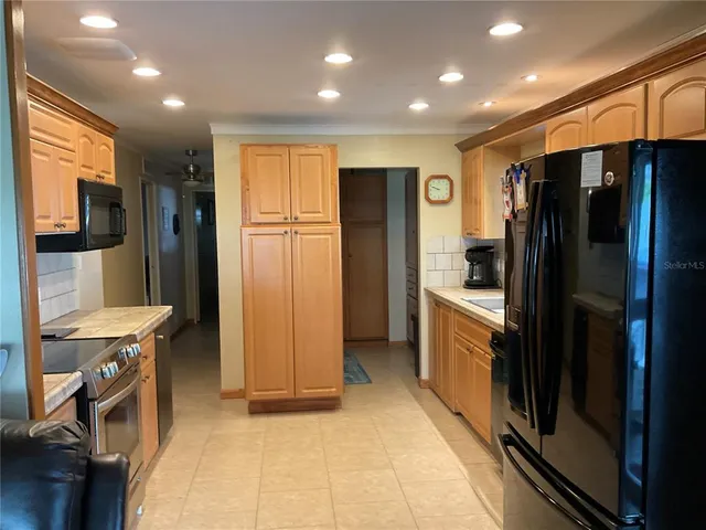 a bathroom with a granite countertop sink a mirror and a shower