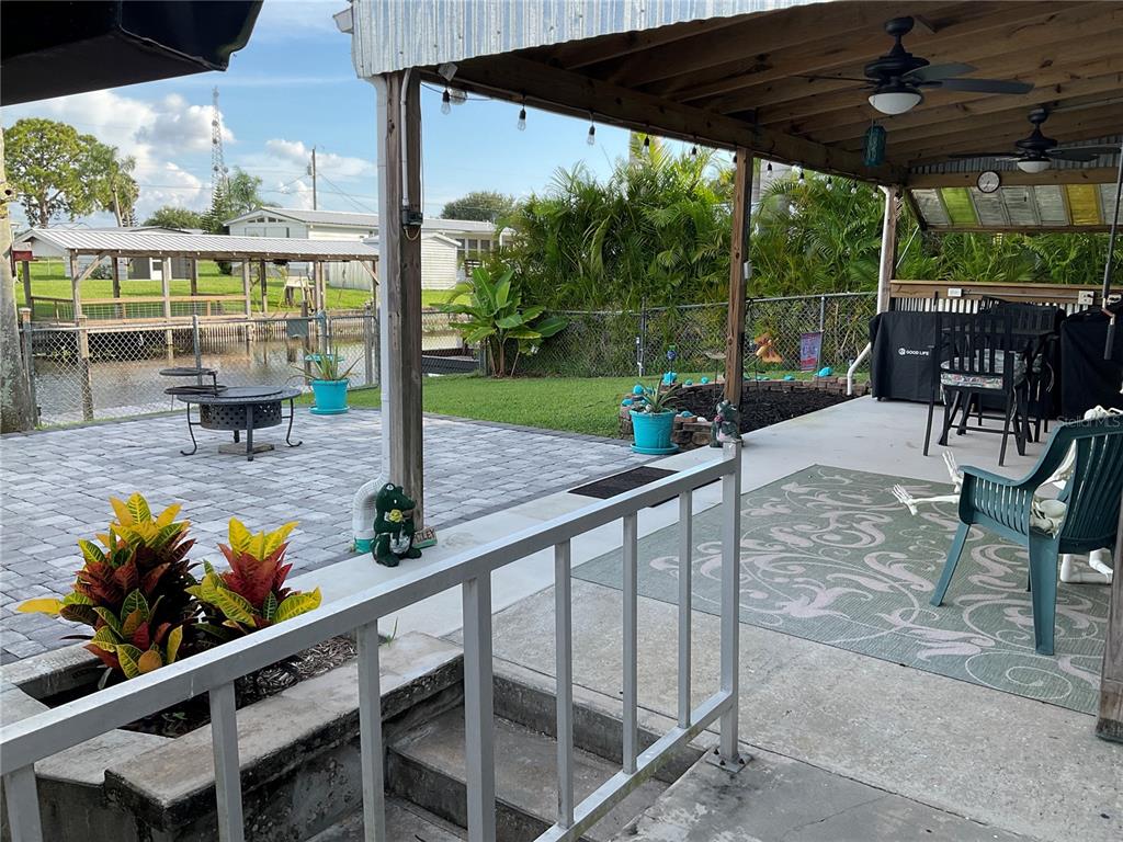 1558 Chobee Street Okeechobee, FL 34974 - Photo 46 of 63 a view of a patio with a table chairs and a backyard