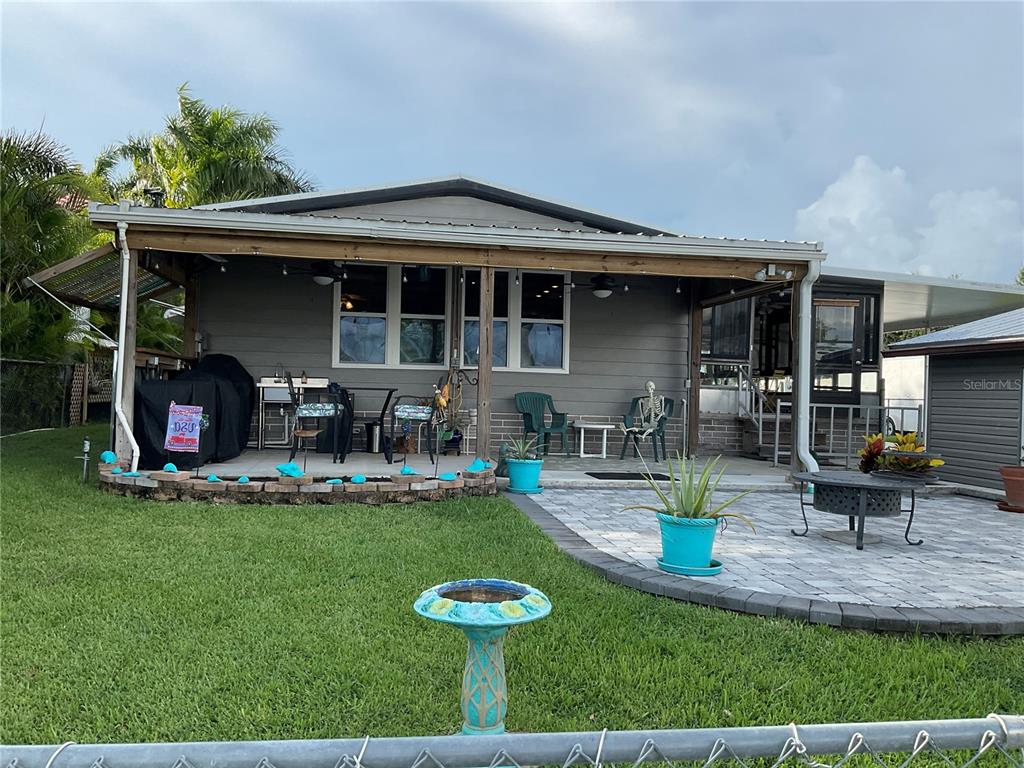 1558 Chobee Street Okeechobee, FL 34974 - Photo 48 of 63 a view of a house with backyard porch and sitting area