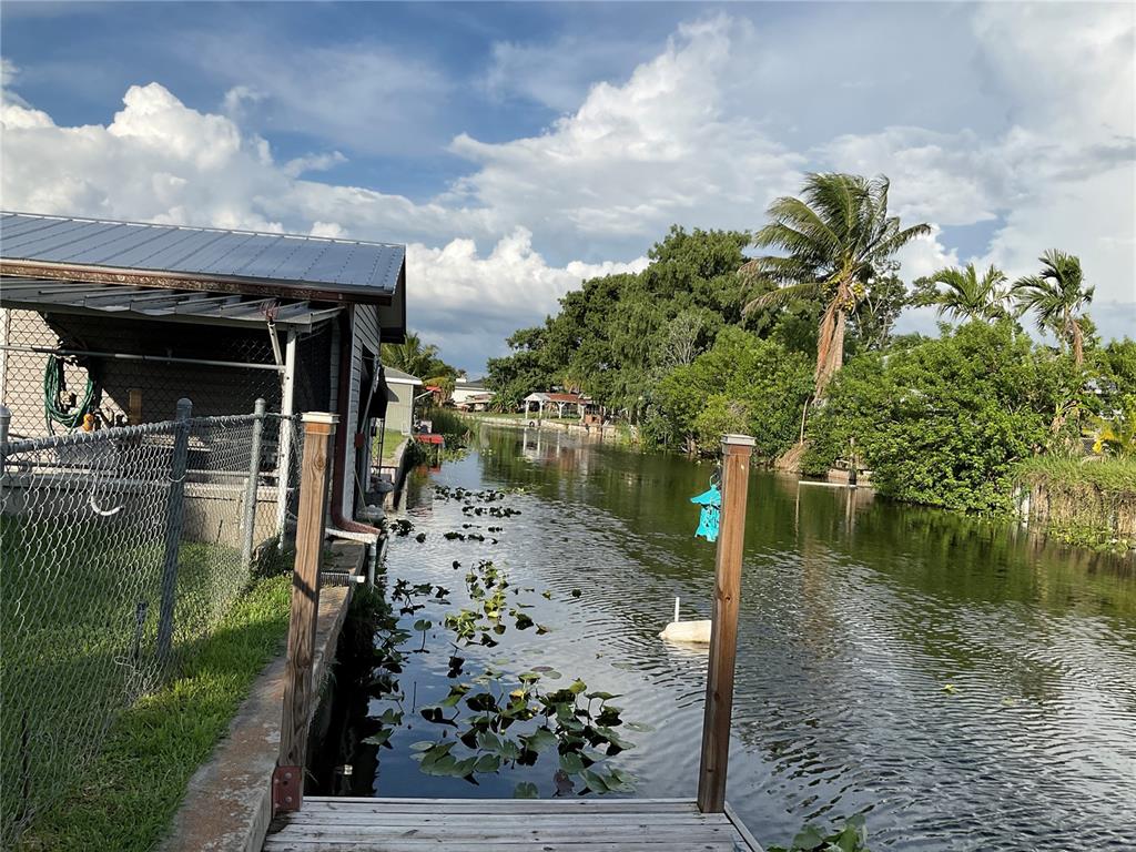 1558 Chobee Street Okeechobee, FL 34974 - Photo 50 of 63 a lake view with boat and trees in the background