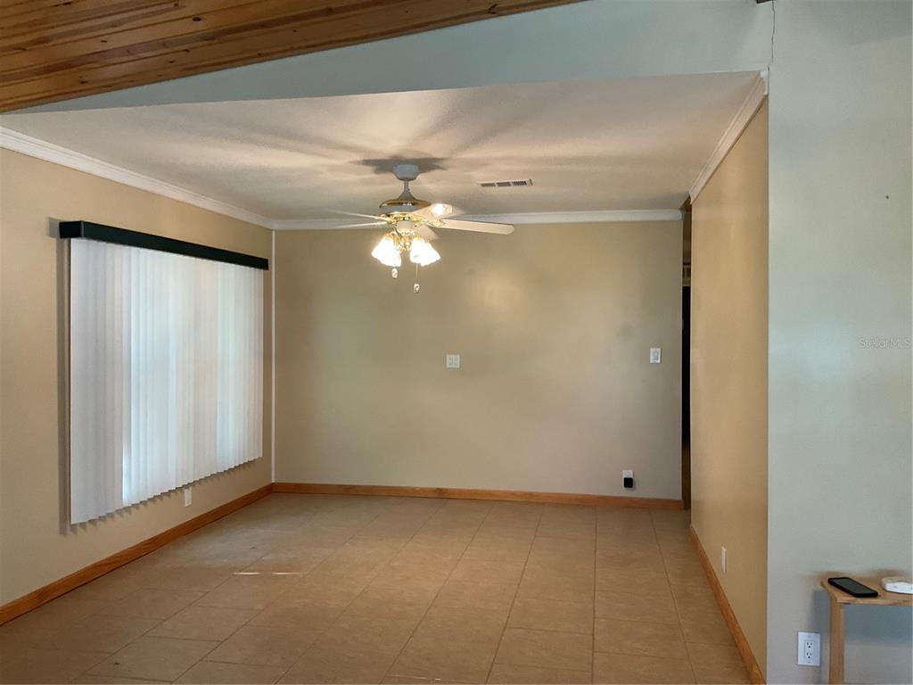 1558 Chobee Street Okeechobee, FL 34974 - Photo 54 of 63 a view of an empty room with a chandelier fan