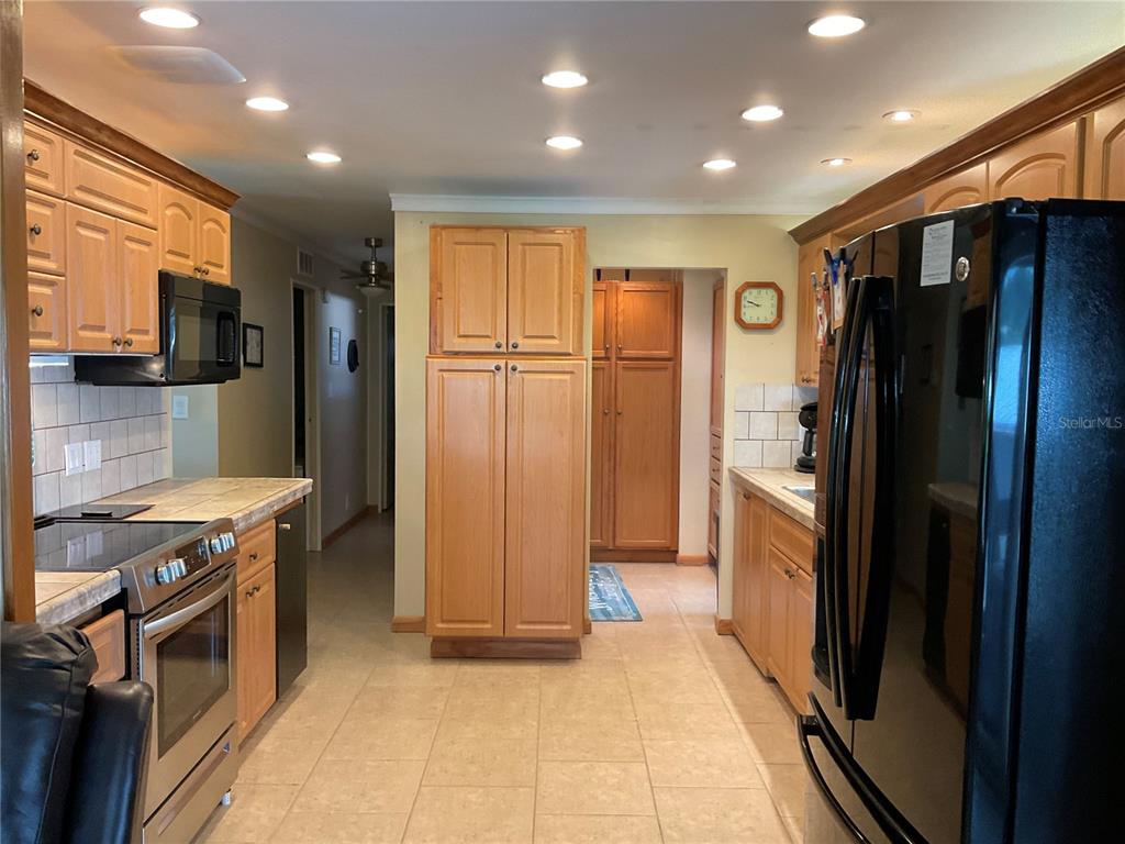 1558 Chobee Street Okeechobee, FL 34974 - Photo 6 of 63 a kitchen with stainless steel appliances granite countertop a refrigerator and a stove