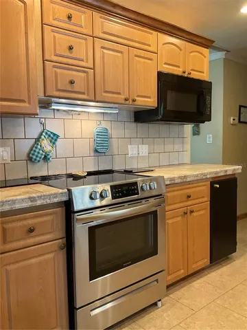a kitchen with a sink and a refrigerator