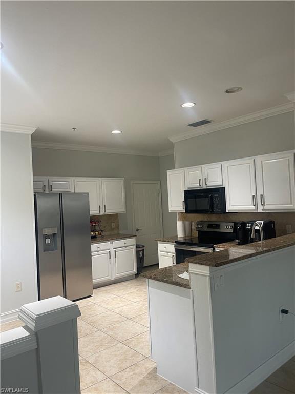 884 Hampton Circle, Unit 159 Naples, FL 34105 - Photo 8 of 28 a kitchen with stainless steel appliances a refrigerator sink stove microwave and cabinets