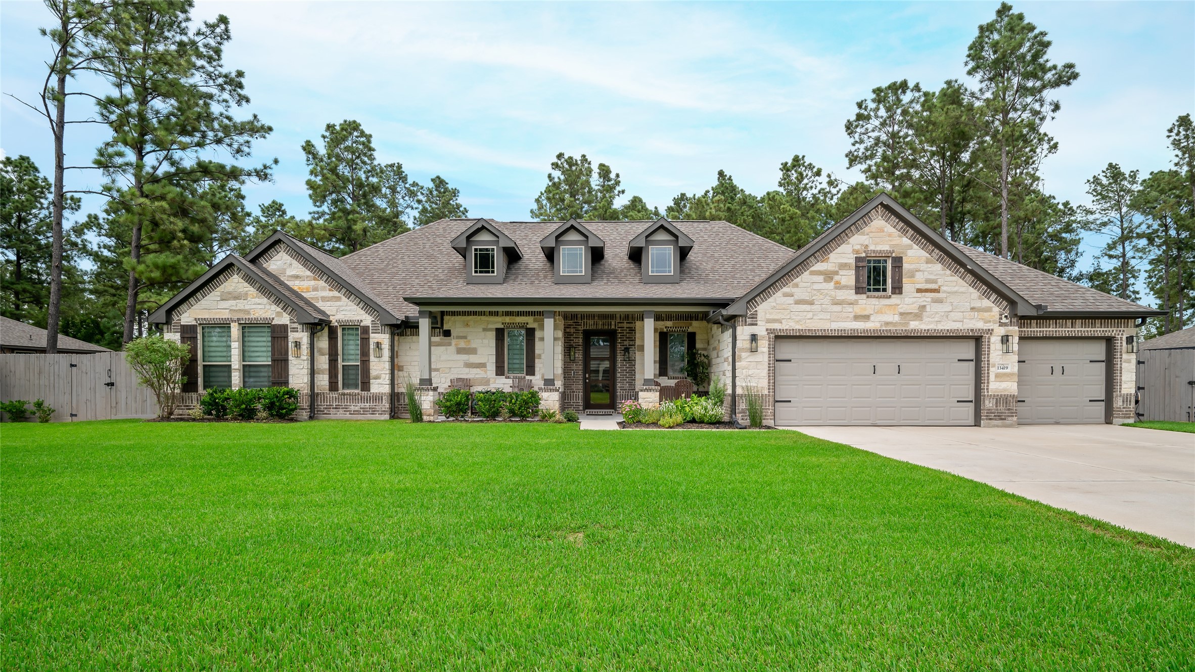 13419 Maverick Trail Road Conroe, TX 77303 - Photo 49 of 49 The Madison floor plan with a stone-and-brick exterior and an oversized three-car garage.