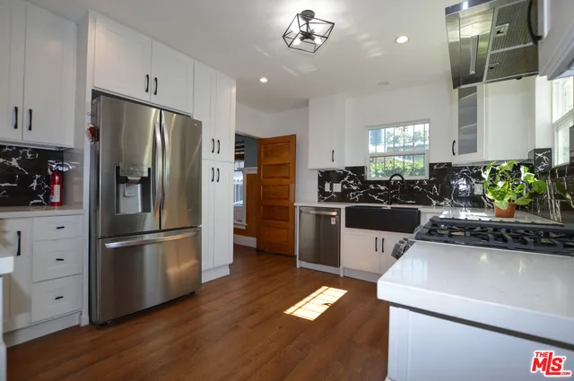 a kitchen with a refrigerator and a sink