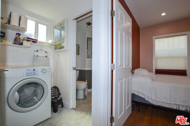 a bedroom with a bed and a television