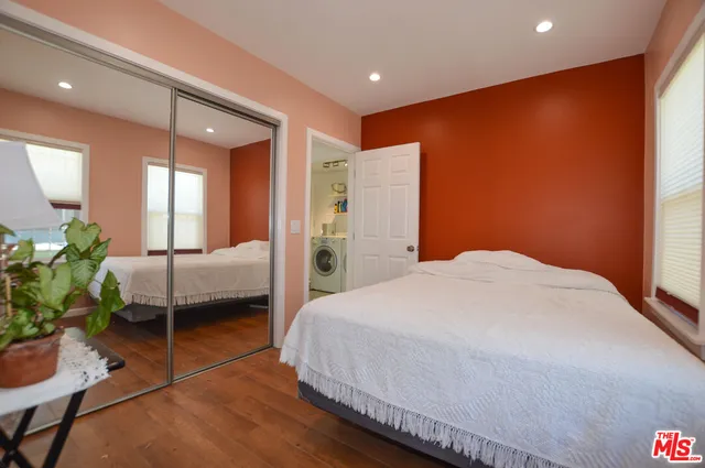 a bedroom with a bed and potted plant