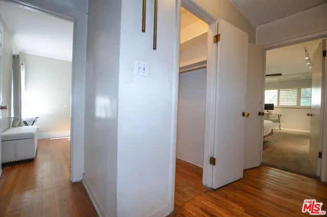 a view of a hallway with wooden floor windows and livingroom
