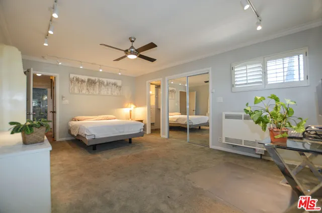 a bedroom with furniture and a potted plant