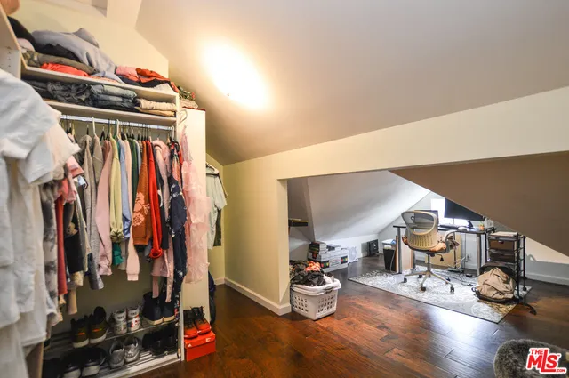 a bedroom with a bed and flat screen tv