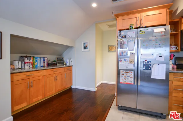 a kitchen with stainless steel appliances granite countertop a stove and a refrigerator