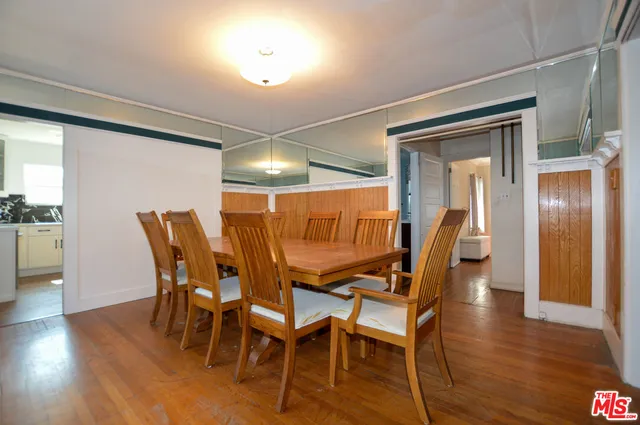 a dining room with furniture and wooden floor