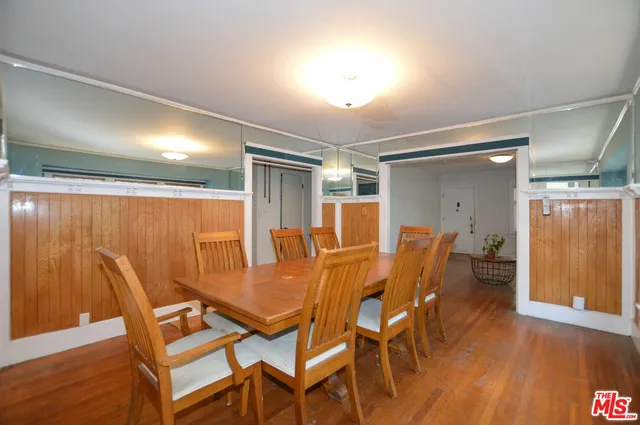 a dining room with furniture and wooden floor