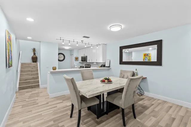 a view of a dining room with furniture and wooden floor
