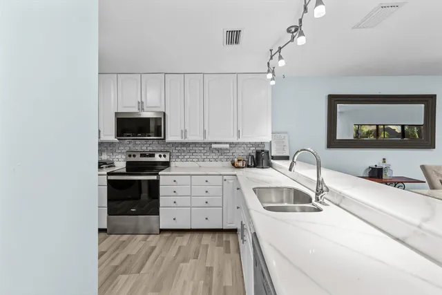 a kitchen with a sink stove and microwave