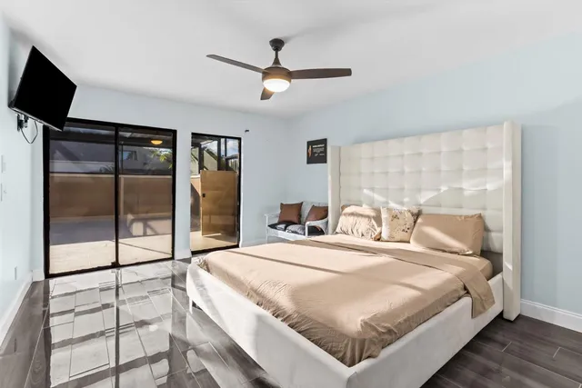 a bedroom with a bed and a flat screen tv