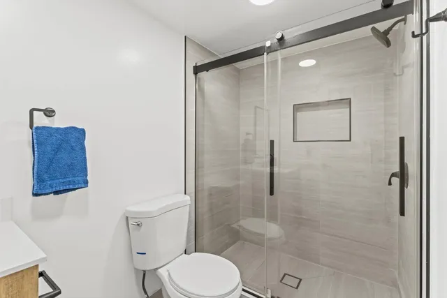 a bathroom with a toilet and a shower