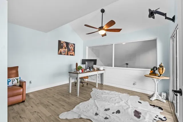 a living room with furniture and a wooden floor