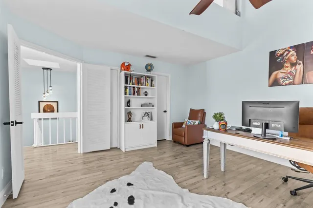a living room with furniture and a wooden floor