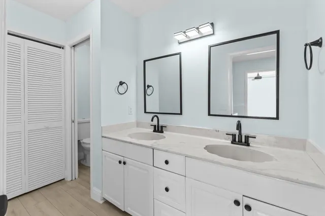 a bathroom with 2 sink and a mirror