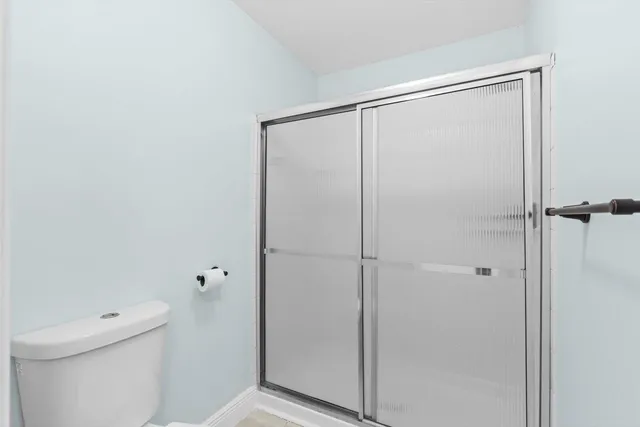 a bathroom with a shower and a toilet