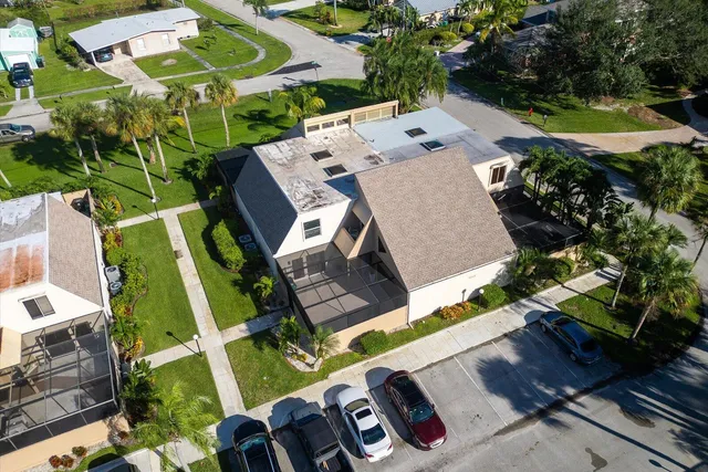 an aerial view of a house with a yard