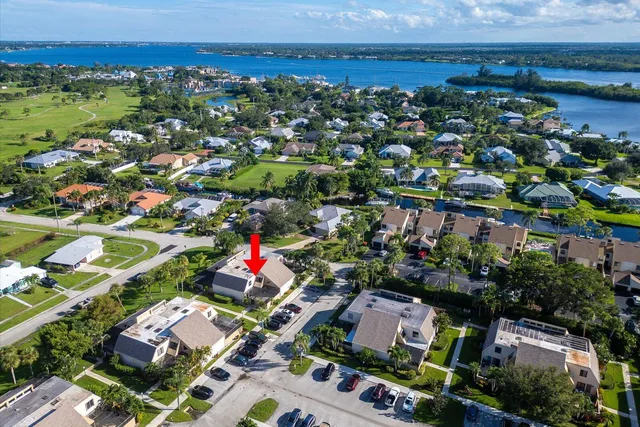 an aerial view of residential houses with outdoor space and street view