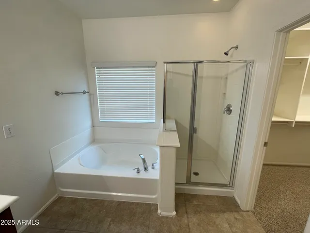a bathroom with a bathtub and shower