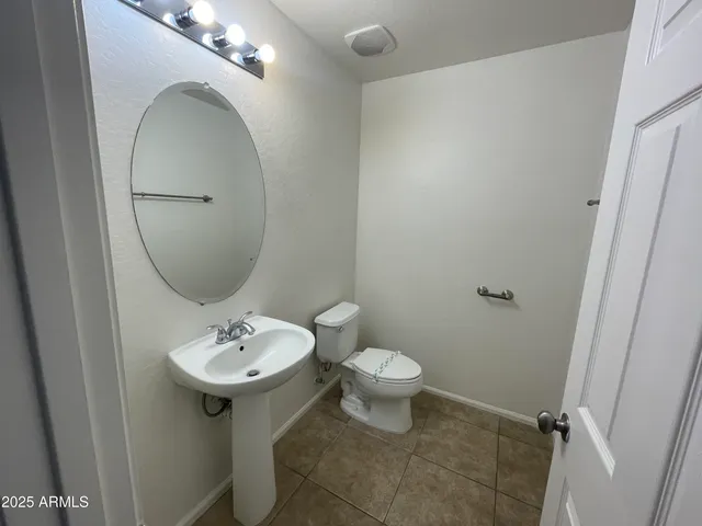 a bathroom with a sink toilet and a mirror
