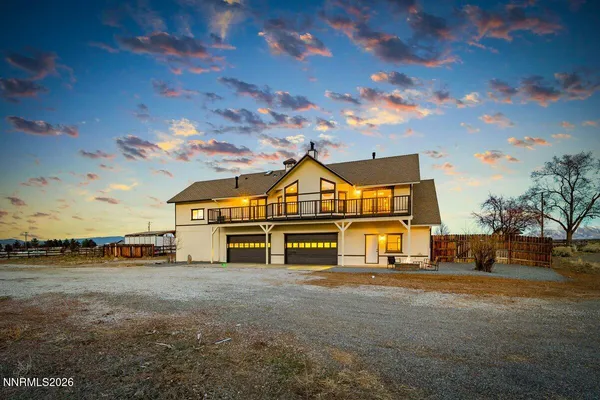 a view of a house with pool and a yard