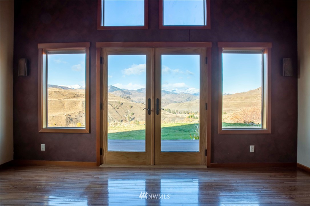 16 French Creek Road Pateros, WA 98846 - Photo 6 of 37 a view of an empty room with wooden floor and a window