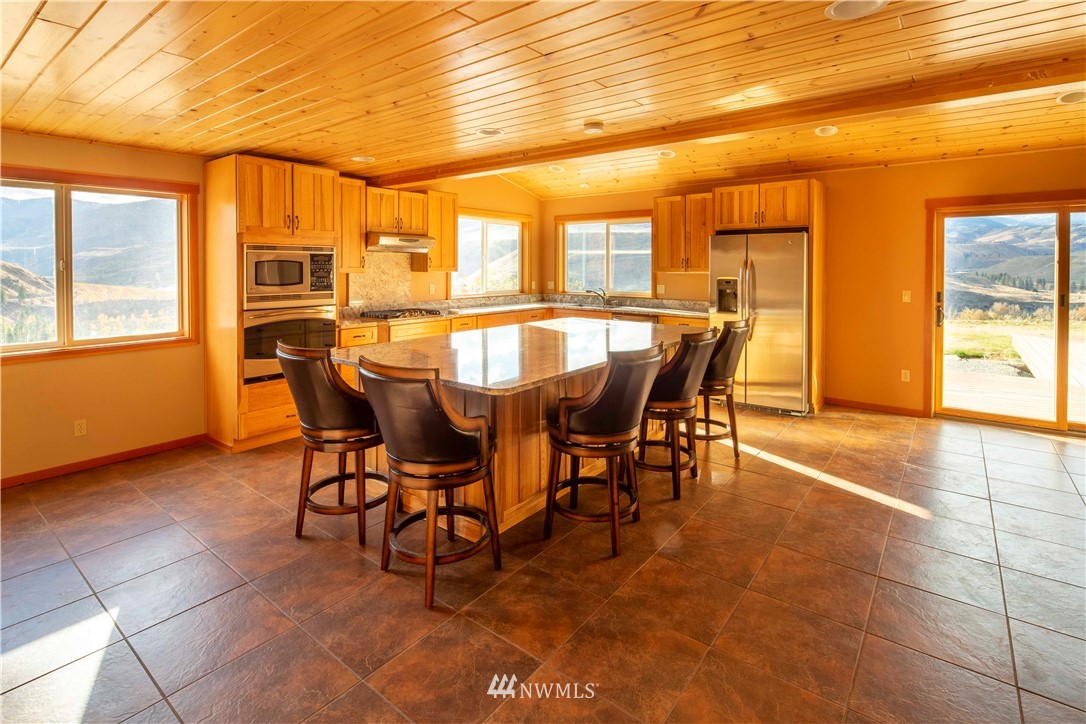 16 French Creek Road Pateros, WA 98846 - Photo 8 of 37 a view of a dining room with furniture and a window