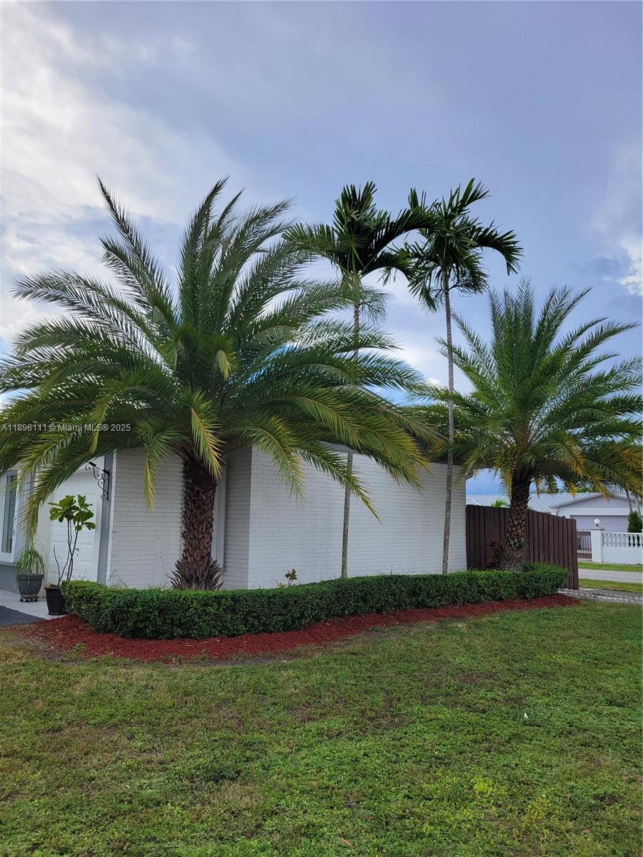 12764 Southwest 46th Lane, Unit 12764 Miami, FL 33175 - Photo 1 of 13 a front view of house with yard and palm tree