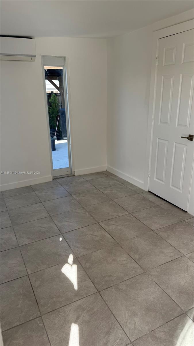 12764 Southwest 46th Lane, Unit 12764 Miami, FL 33175 - Photo 12 of 13 a view of empty room with wooden floor and fan
