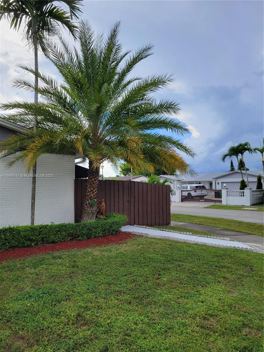 12764 Southwest 46th Lane, Unit 12764 Miami, FL 33175 - Photo 2 of 13 a garden with palm trees