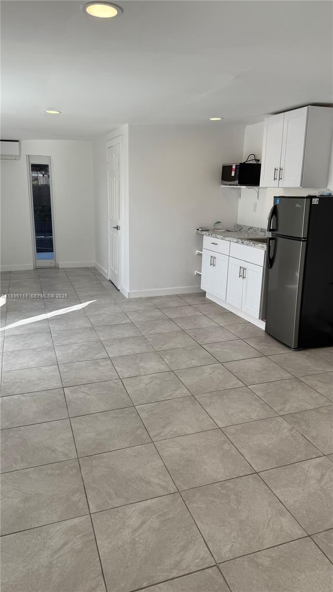 12764 Southwest 46th Lane, Unit 12764 Miami, FL 33175 - Photo 4 of 13 a view of a kitchen with a sink and a stove top oven