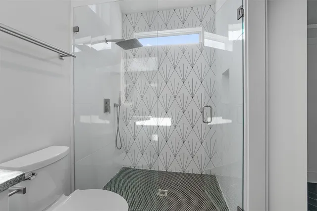 a bathroom with a toilet and a shower