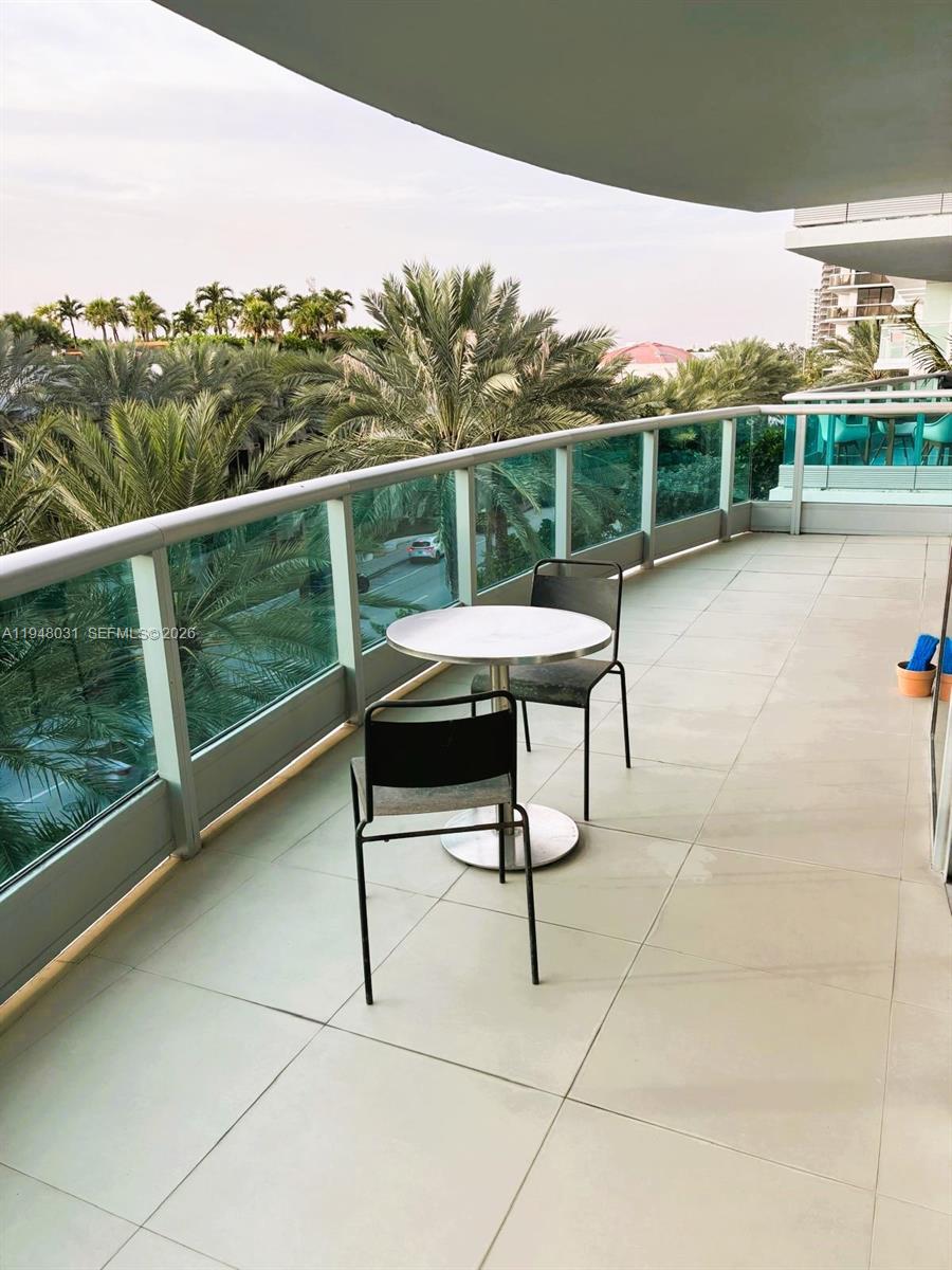 9401 Collins Avenue, Unit 401 Surfside, FL 33154 - Photo 15 of 28 a view of a chairs and table in the balcony