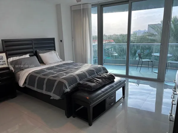 a bedroom with a bed lamp and window