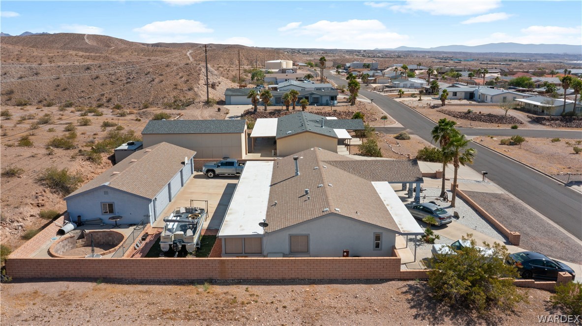784 Pegasus Ranch Road Bullhead City, AZ 86429 - Photo 100 of 100 Property featuring a single-story residence with a pitched roof and light-colored exterior