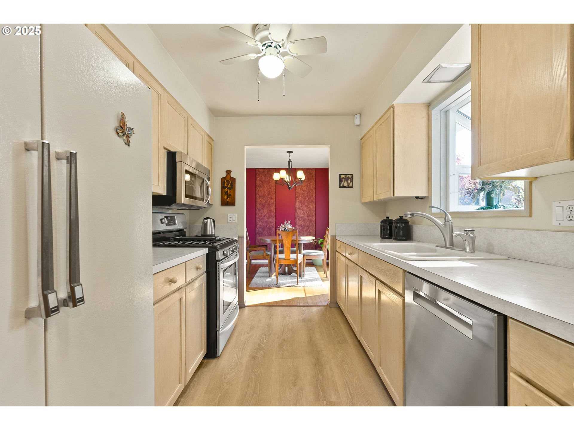 1055 Southeast 214th Avenue Gresham, OR 97030 - Photo 16 of 38 a kitchen with stainless steel appliances a refrigerator a sink dishwasher a stove with white cabinets