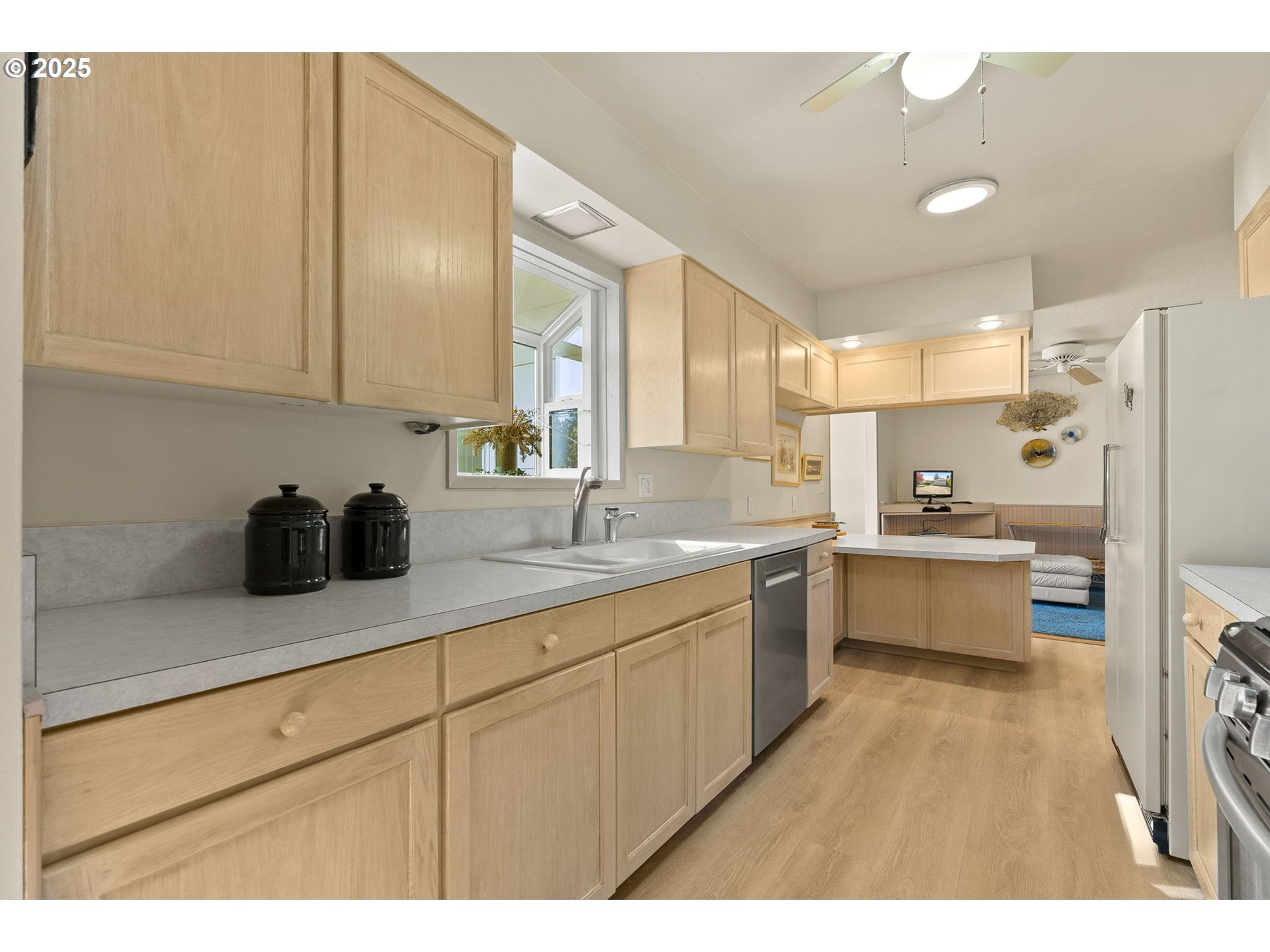 1055 Southeast 214th Avenue Gresham, OR 97030 - Photo 17 of 38 a large kitchen with kitchen island a sink stainless steel appliances and cabinets