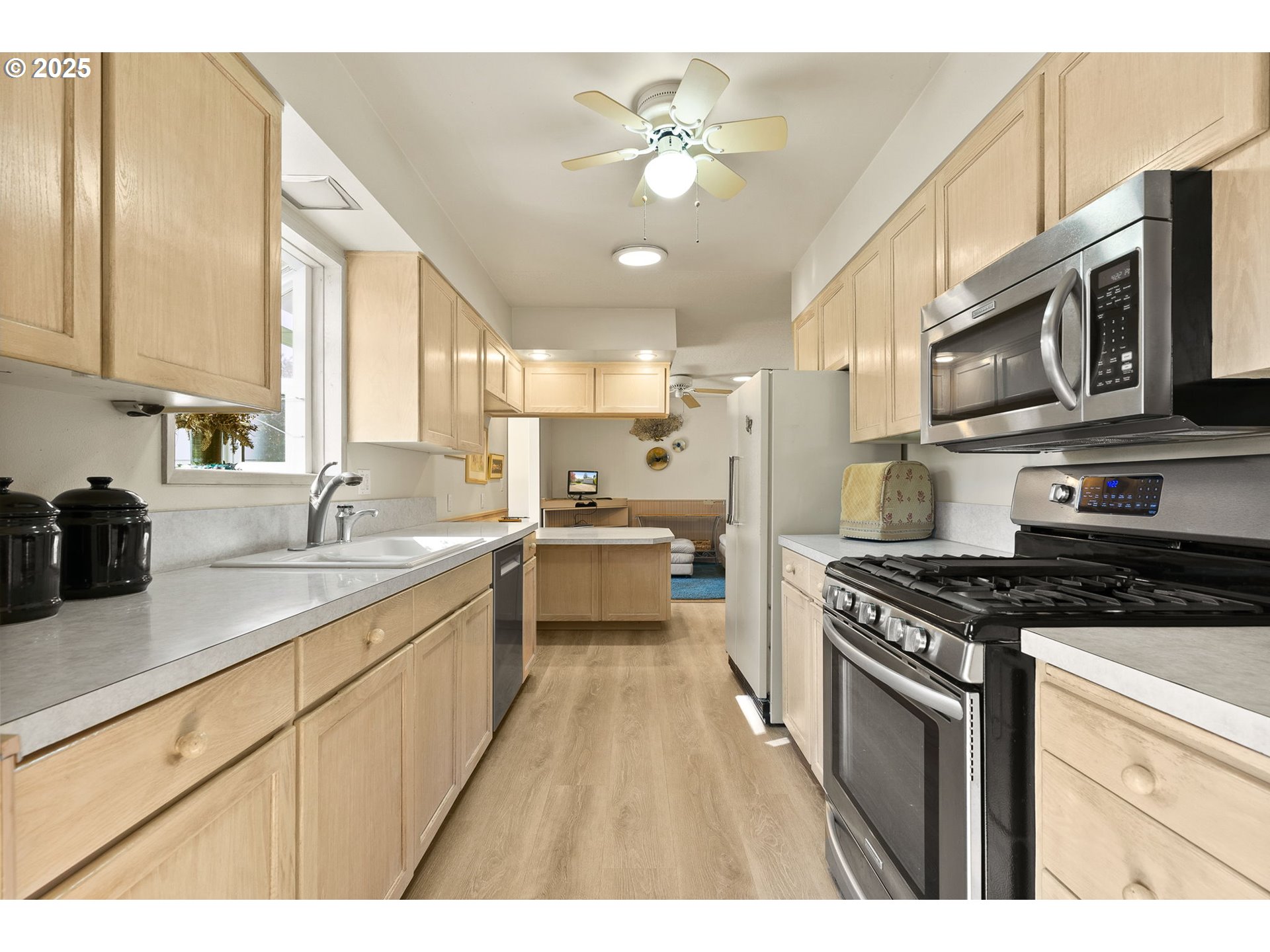 1055 Southeast 214th Avenue Gresham, OR 97030 - Photo 18 of 38 a kitchen with stainless steel appliances granite countertop a sink a stove oven a counter space and cabinets