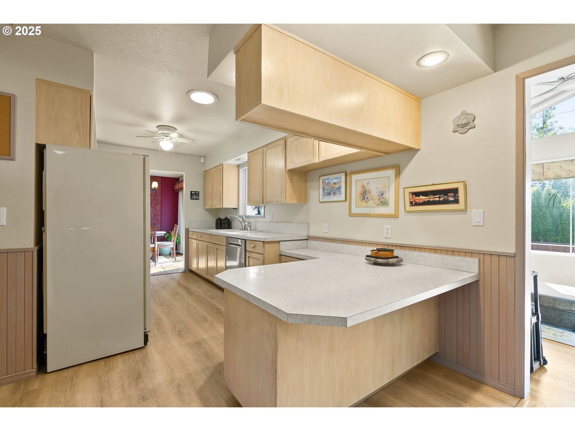 1055 Southeast 214th Avenue Gresham, OR 97030 - Photo 20 of 38 a open kitchen with a refrigerator a stove top oven and a view of living room