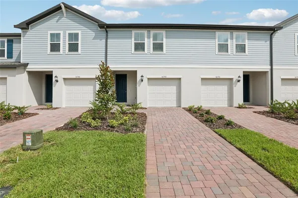 a front view of a house with a yard and garage